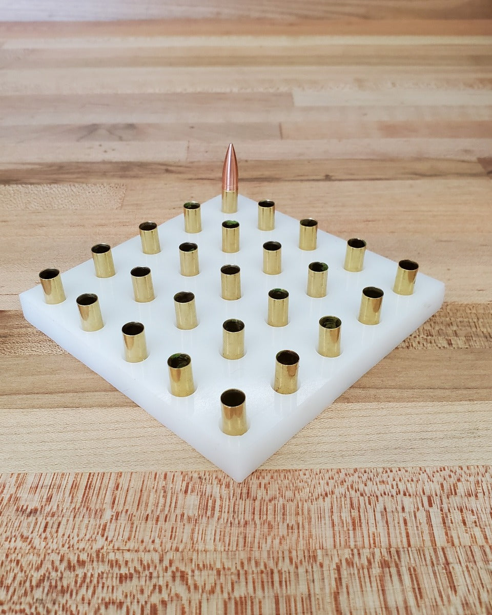 white square reloading tray with indentations to hold brass cartridges